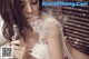 A woman in a wedding dress smoking an electronic cigarette.