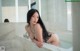 A woman sitting in a bathtub in a bathroom.